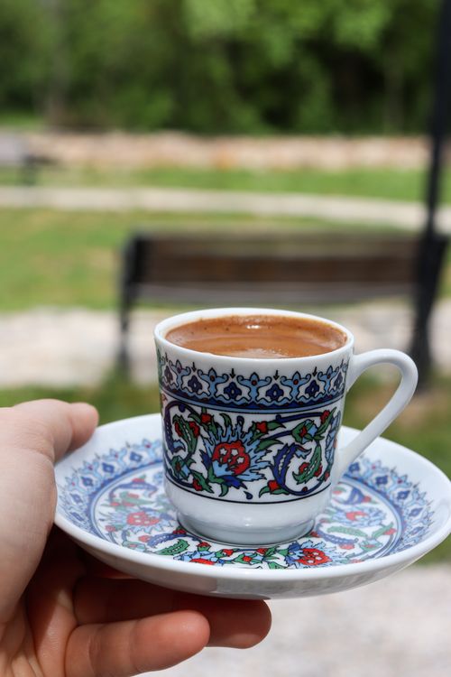 Free Colorful Turkish coffee cup with intricate design held outdoors, perfect for cultural themes. Stock Photo