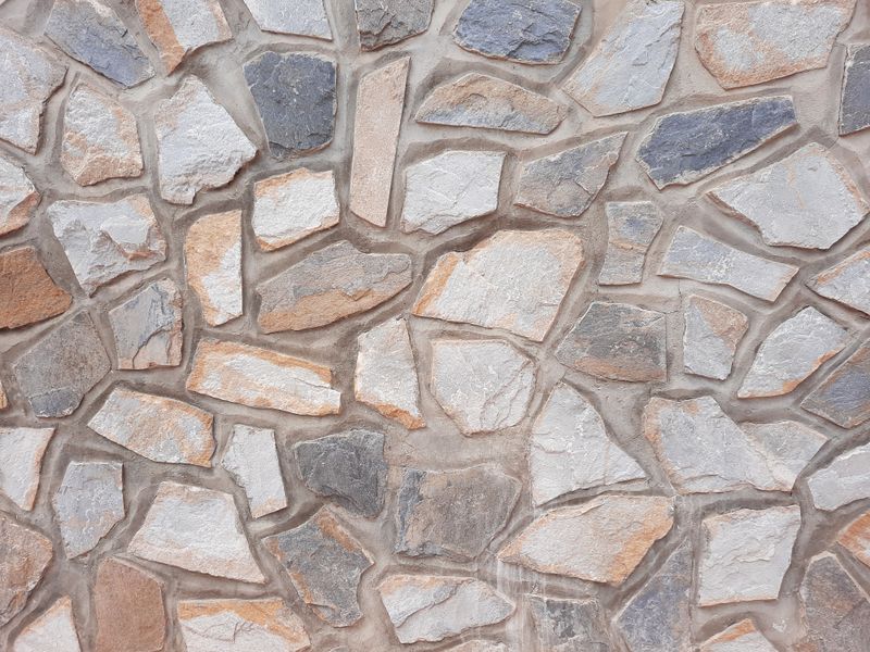 Irregular stone wall with mortar between each stone