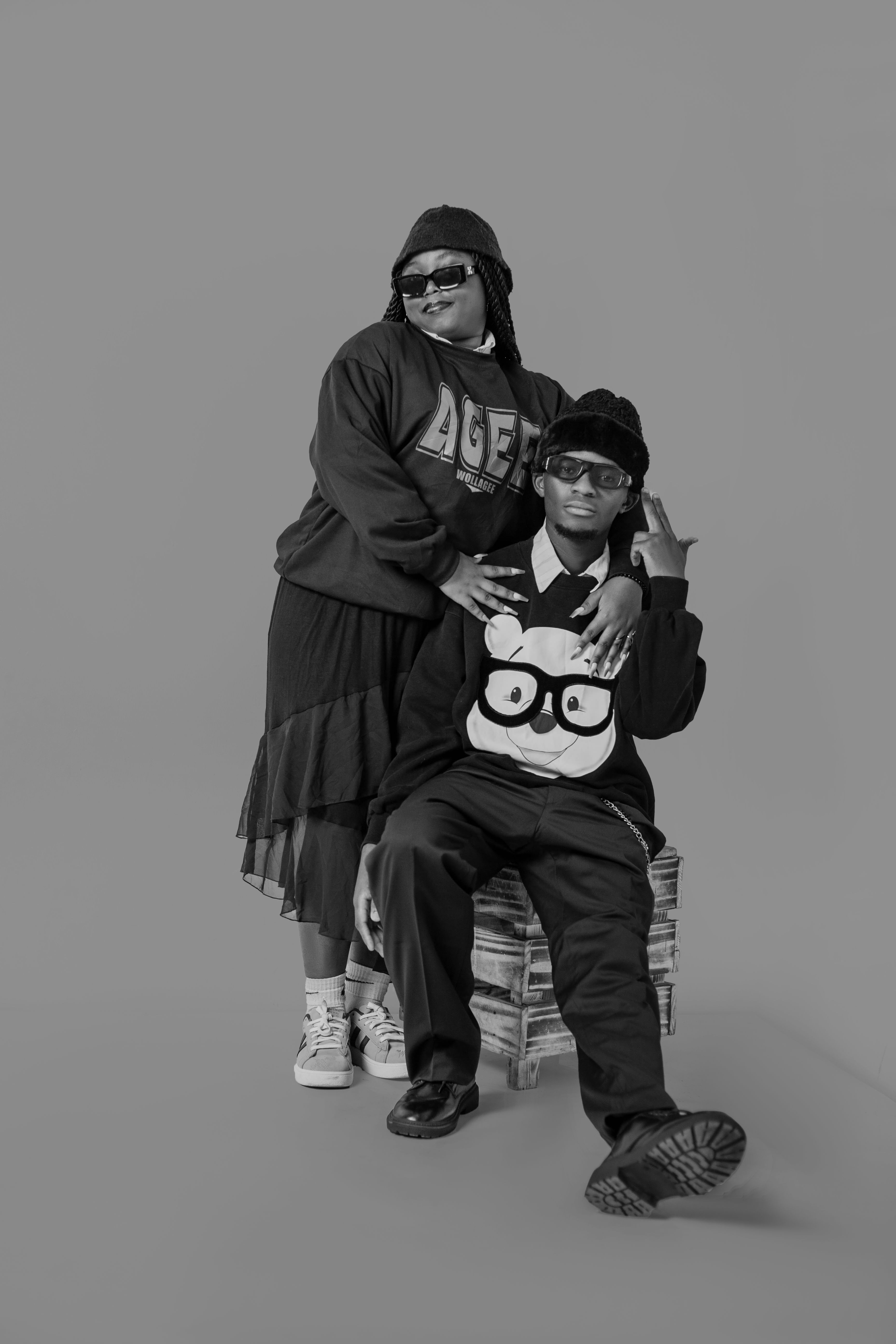 Fashion-forward couple in black and white attire, showcasing unique style and confidence.