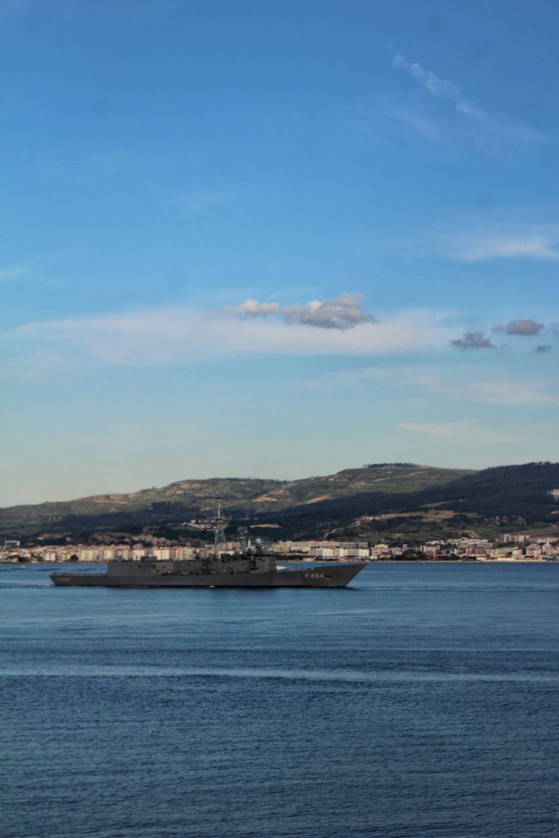 Navy ship cruising off the coast