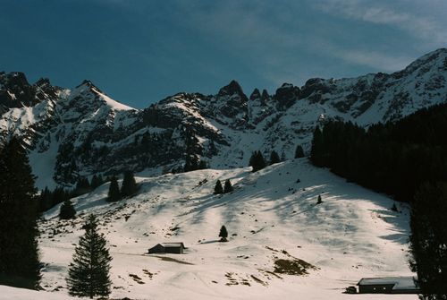 Free Breathtaking view of alpine mountains covered in snow under a clear blue sky. Stock Photo