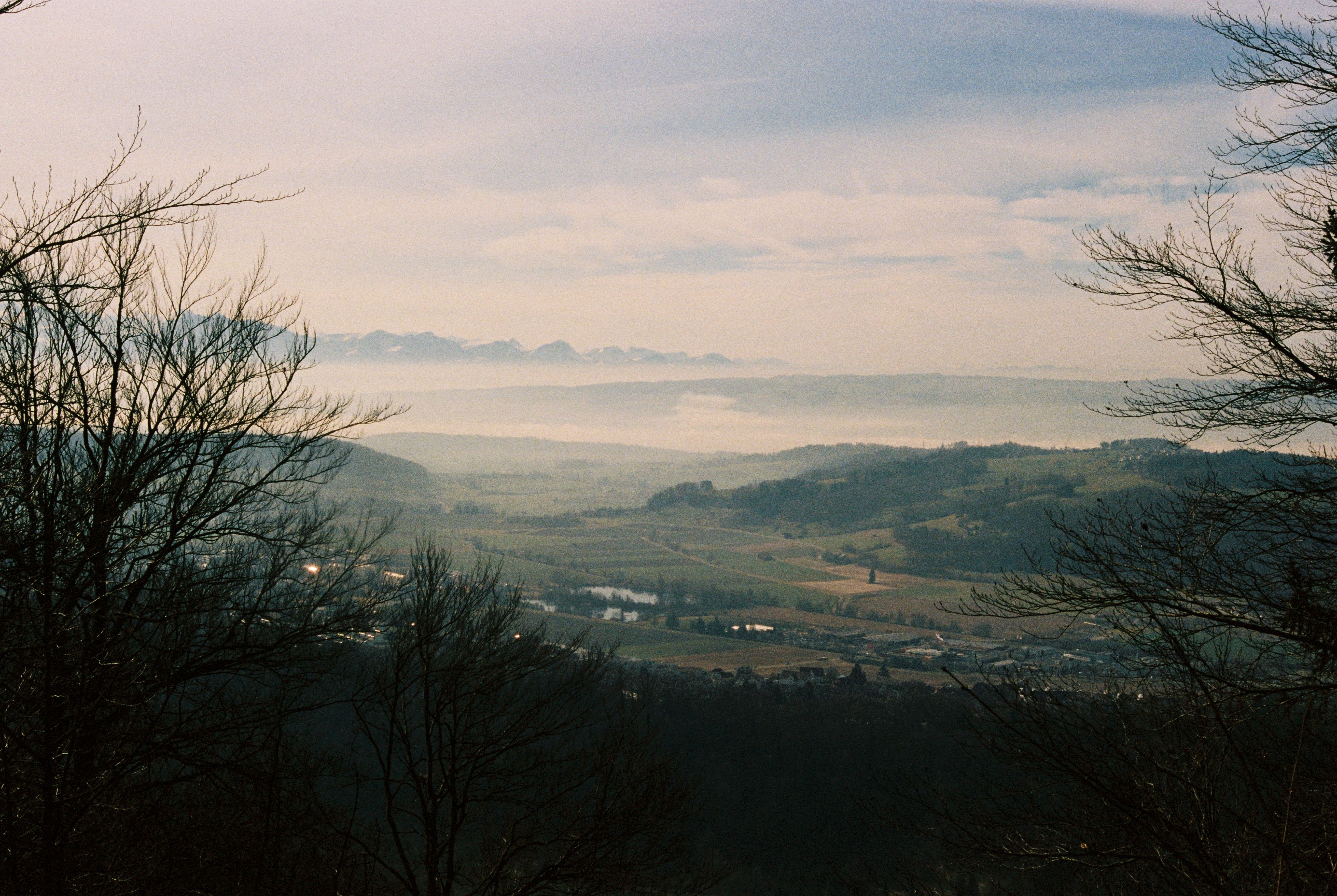 Serene view of Alpine mountains and misty valley, ideal for nature lovers.