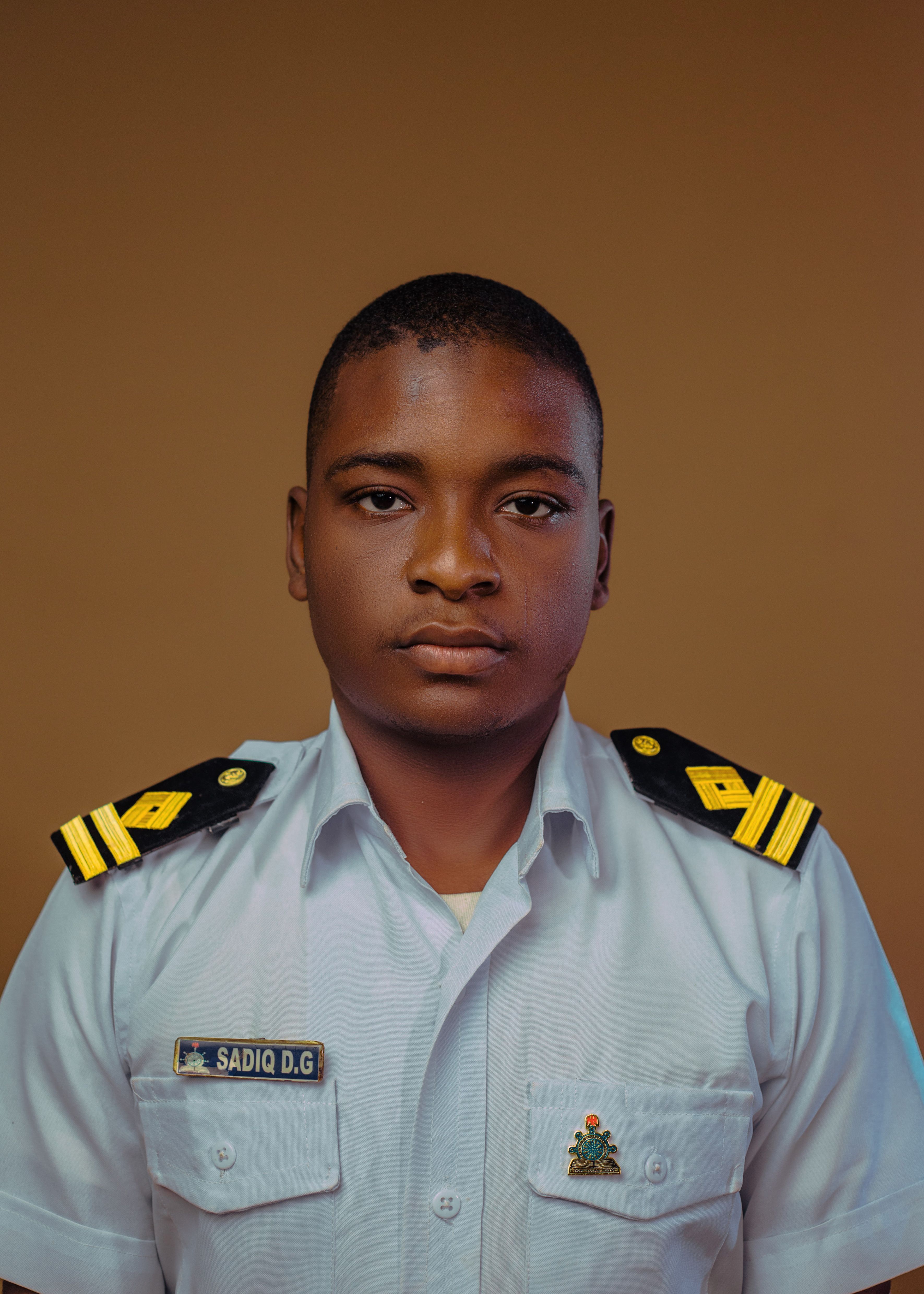 Portrait of a young navy officer in uniform, showcasing leadership qualities.