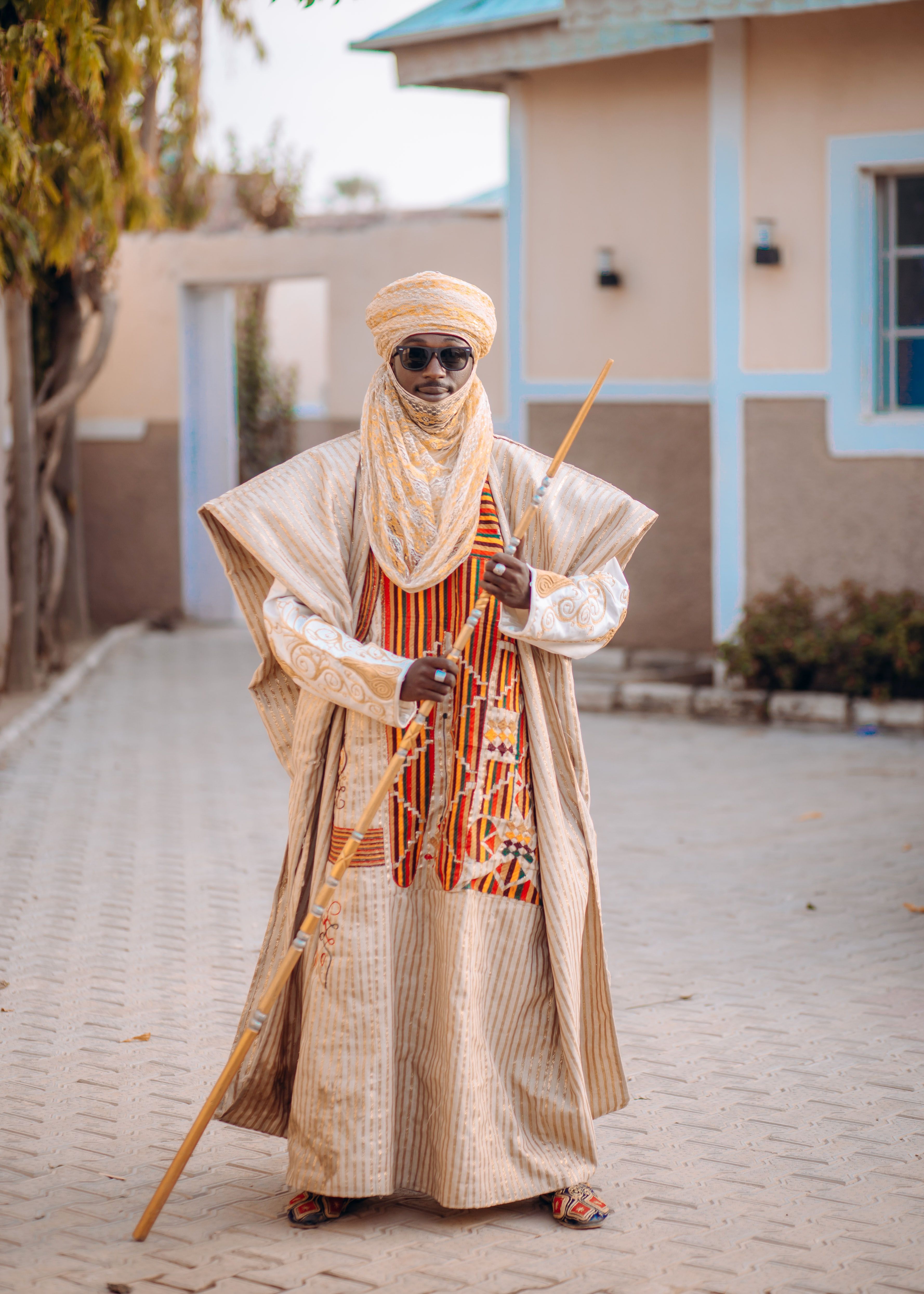 Traditional African Attire with Ornate Walking Staff  Free Stock Photo