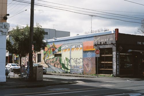 Free Colorful street art mural on a wall in Melbourne, Australia featuring a tram and vibrant designs. Stock Photo