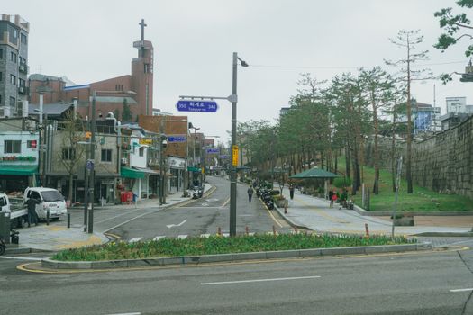 Urban street scene in Seoul, South Korea, showcasing Korean architecture and city life.