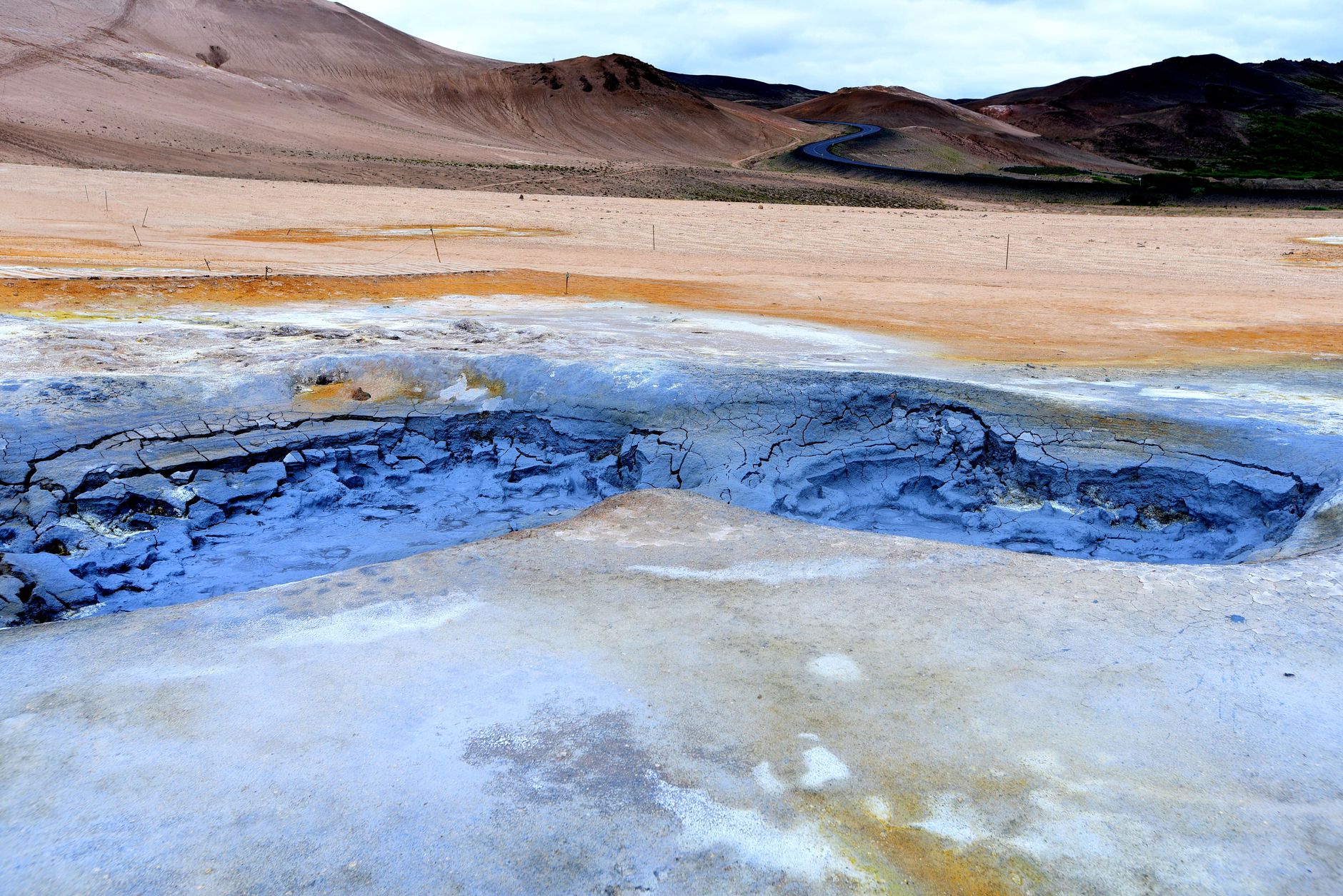 Bubbling grey mud pots and steaming vents at Hverir