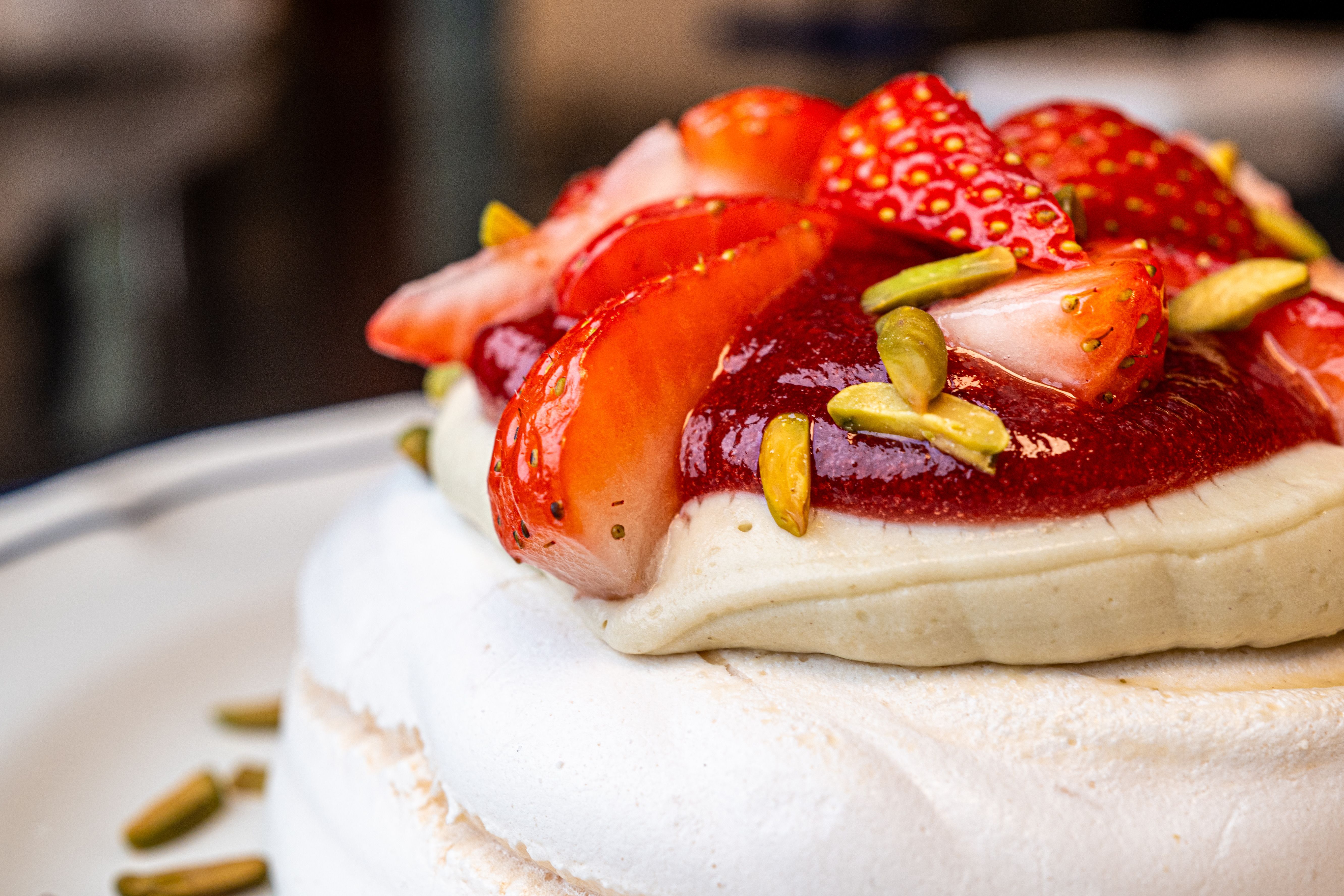 Close-up of a salted pistachio meringue broken to show soft interior