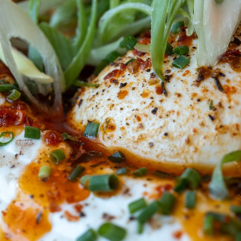 Sichuan Chili Oil Scrambled Eggs with Crispy Doufuru and Scallions on Mantou