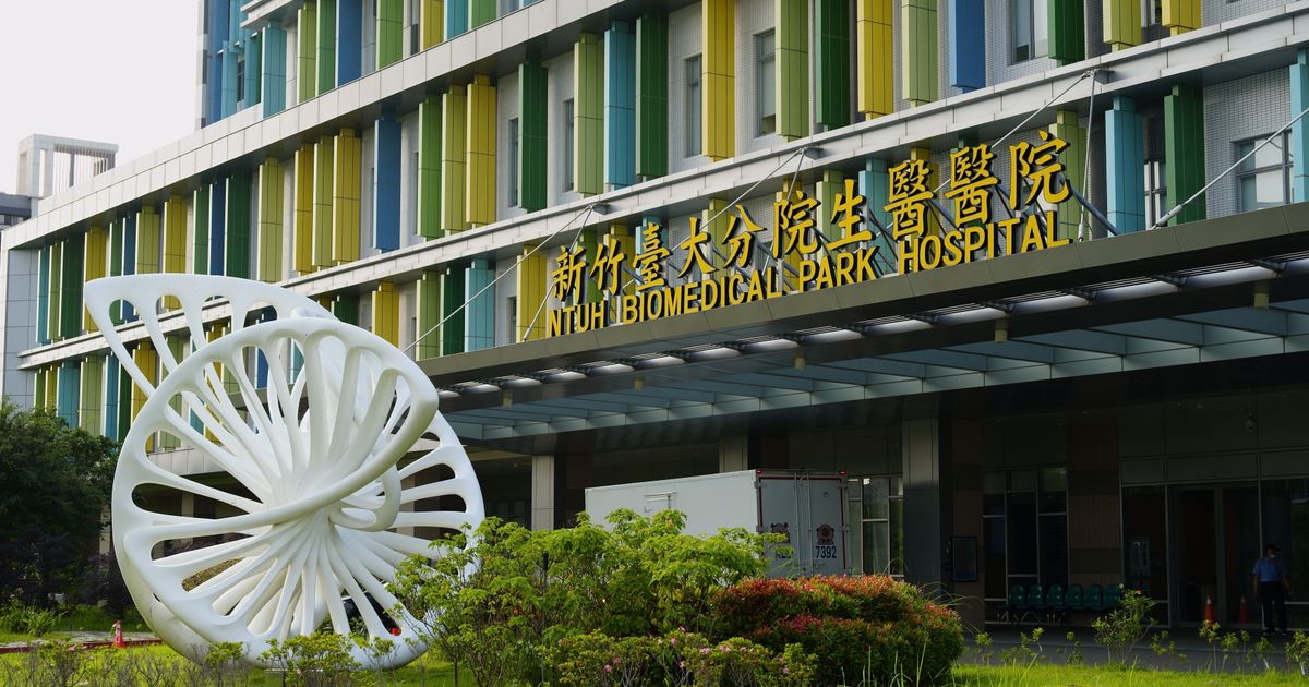 Hospital entrance with modern sculpture and colourful facade
