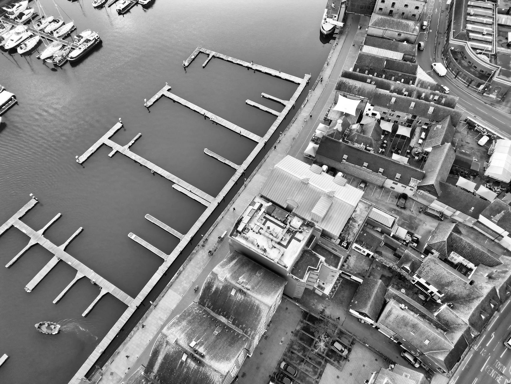 Stunning aerial black-and-white view of Ipswich Marina showcasing a mix of architecture and waterfront docks.