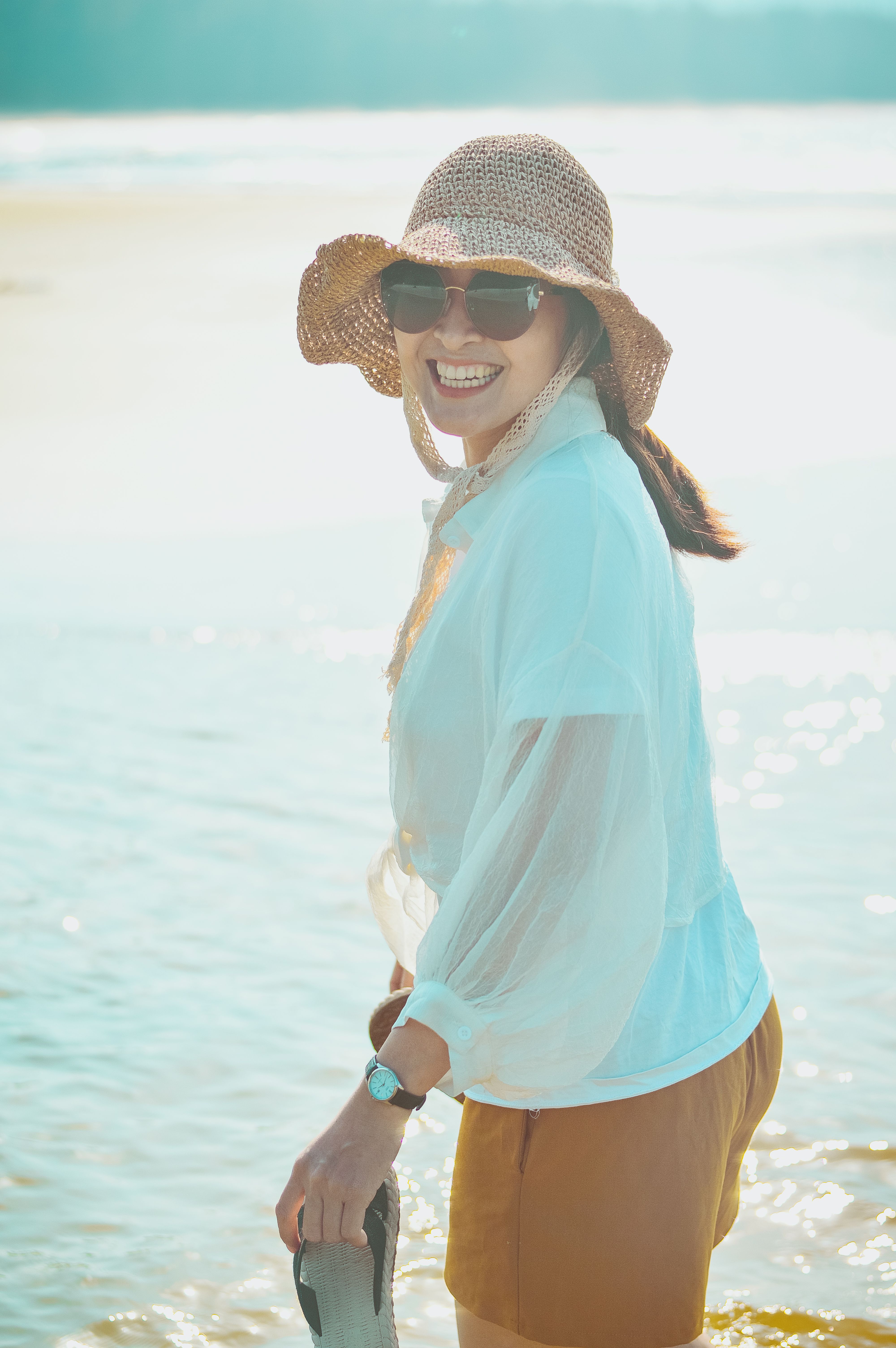Smiling Woman Enjoying a Sunny Beach Day · Free Stock Photo