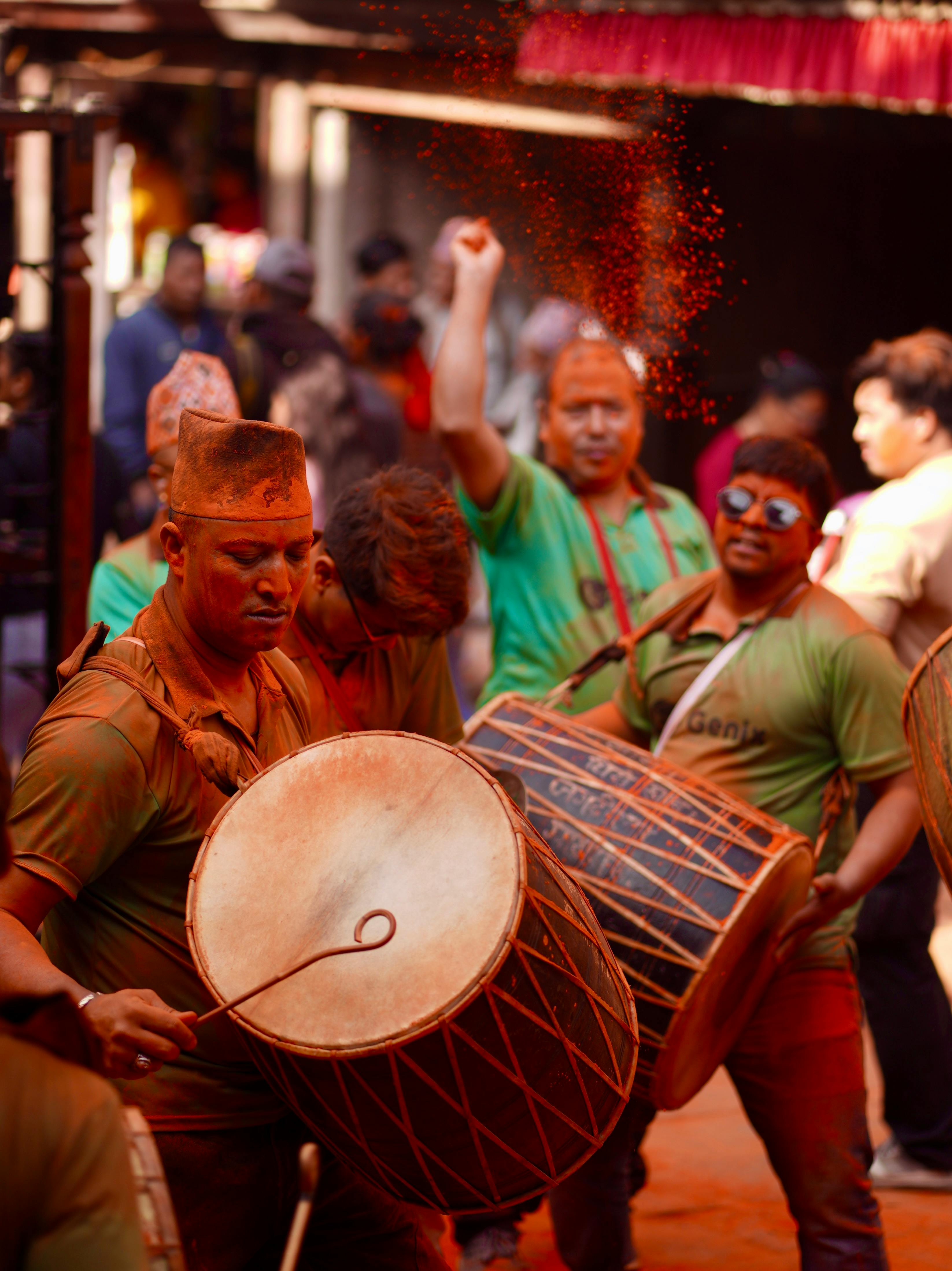 Energetic celebration of Sindoor Jatra in Madhyapur Thimi, Nepal with drummers and vibrant colors.