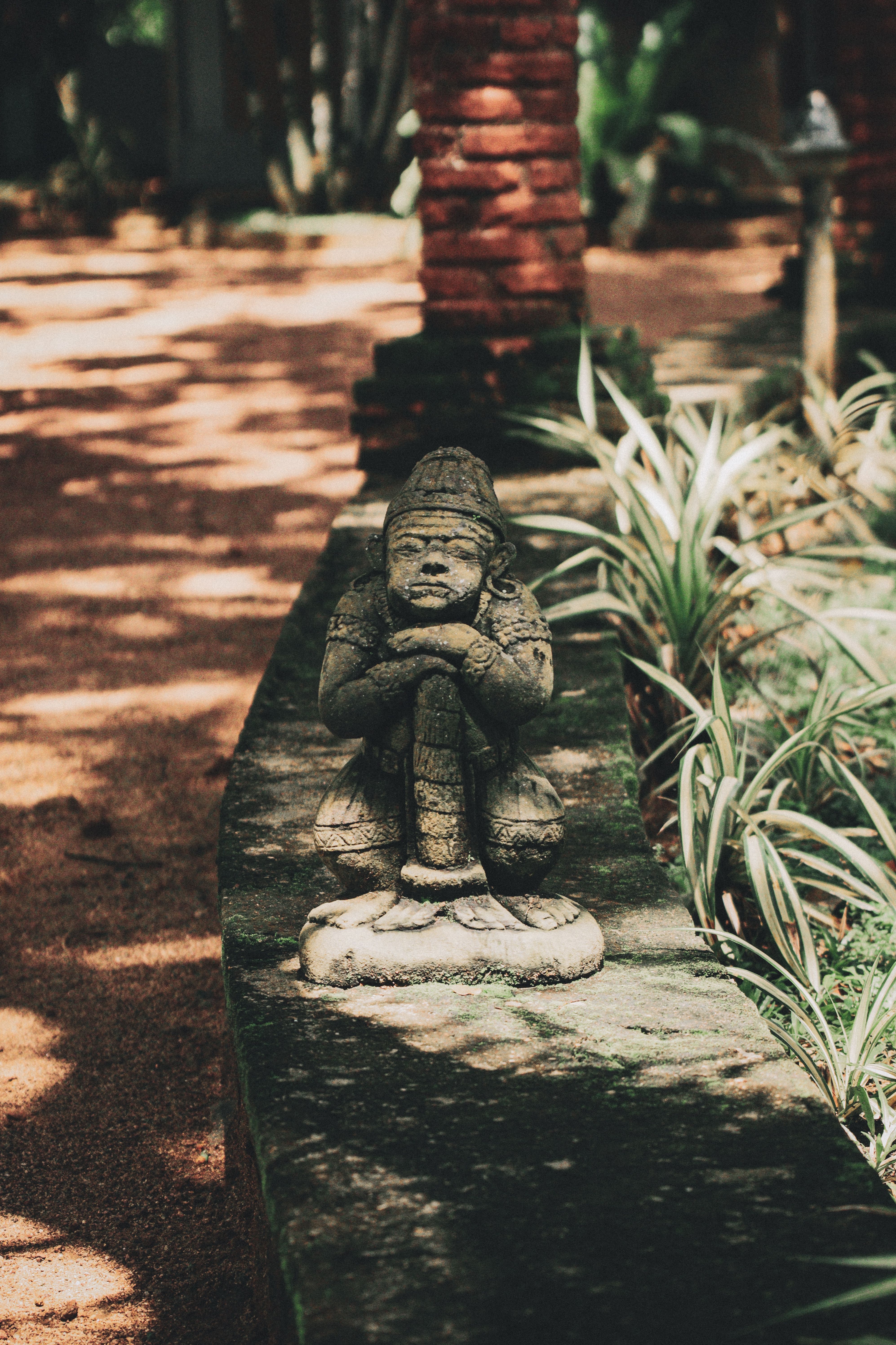 Ancient Stone Sculpture in Tranquil Garden