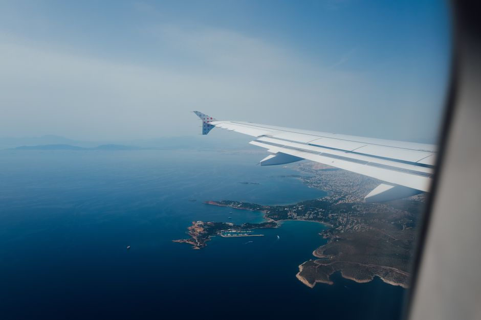Best Private Helicopter Transfer from Crete to Santorini Review: The Ultimate Greek Island-Hopping Experience Review 2026 - Scenic aerial view from airplane window showcasing coastline and sea, perfect for travel content.
