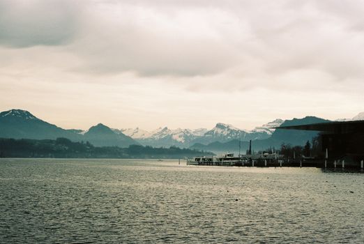 Stunning winter view of Lake Zurich with the Swiss Alps in the background, perfect for travel inspiration.