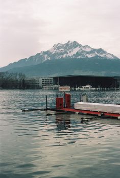 Calm lake reflecting a snow-covered mountain in Switzerland, capturing serene natural beauty.