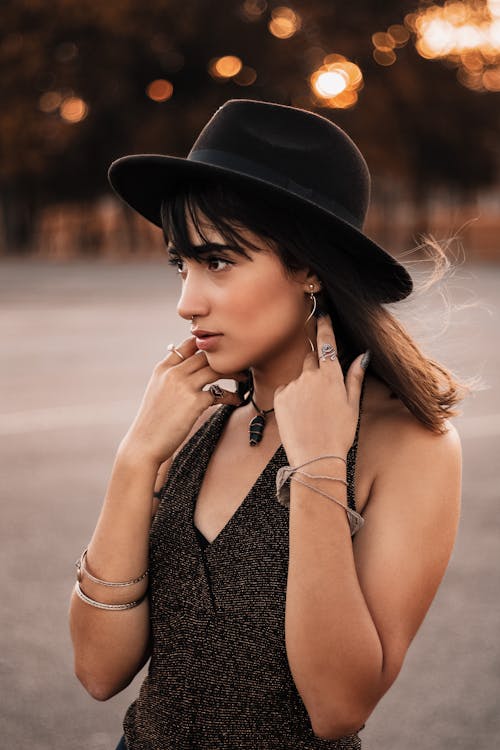 Woman Wearing Black Sleeveless Top and Hat