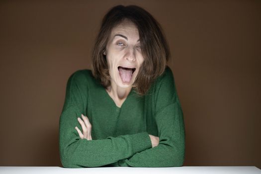 Woman Wearing Green Long Sleeved Shirt Making Face