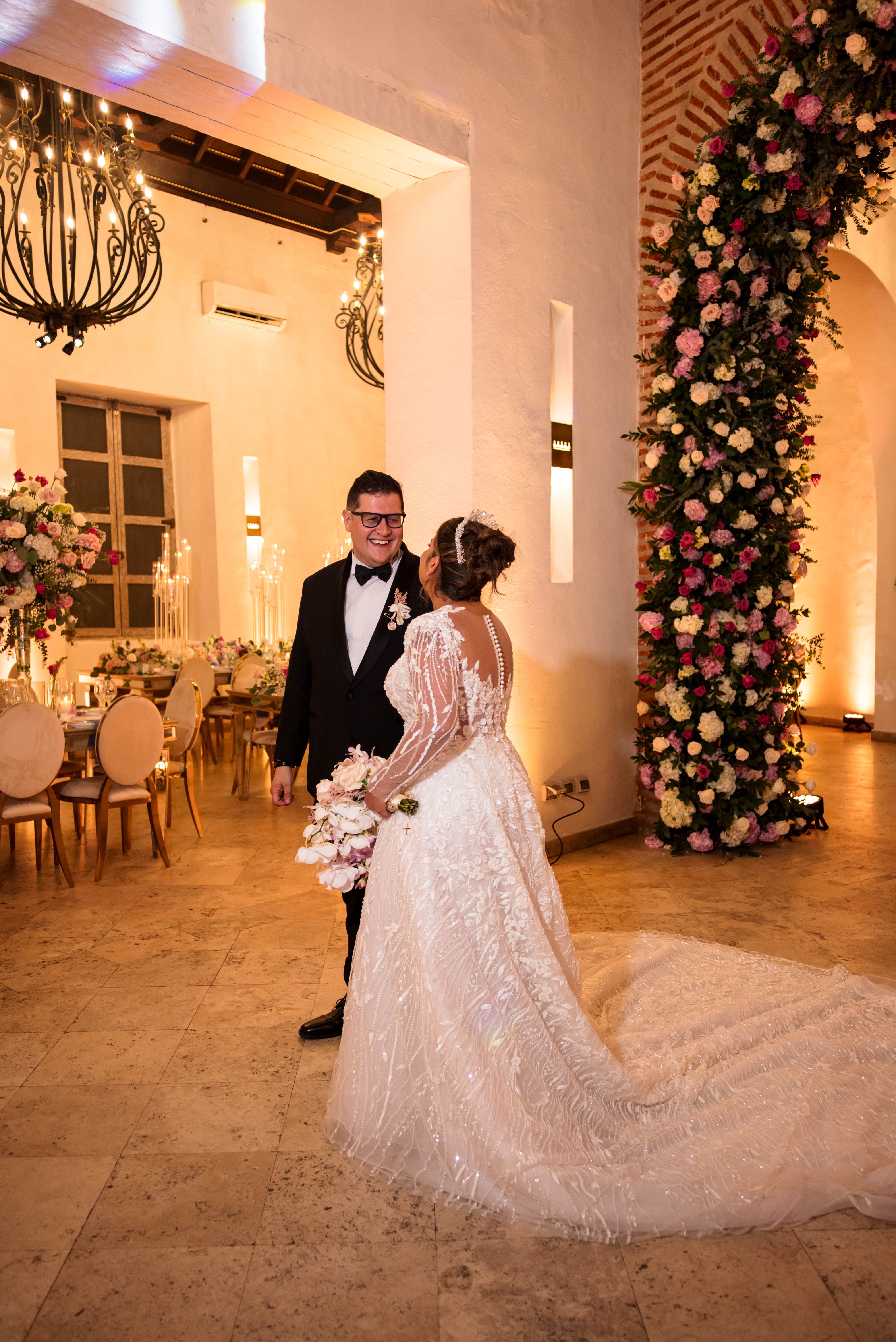 Bride and groom share a romantic moment in elegantly decorated wedding venue.