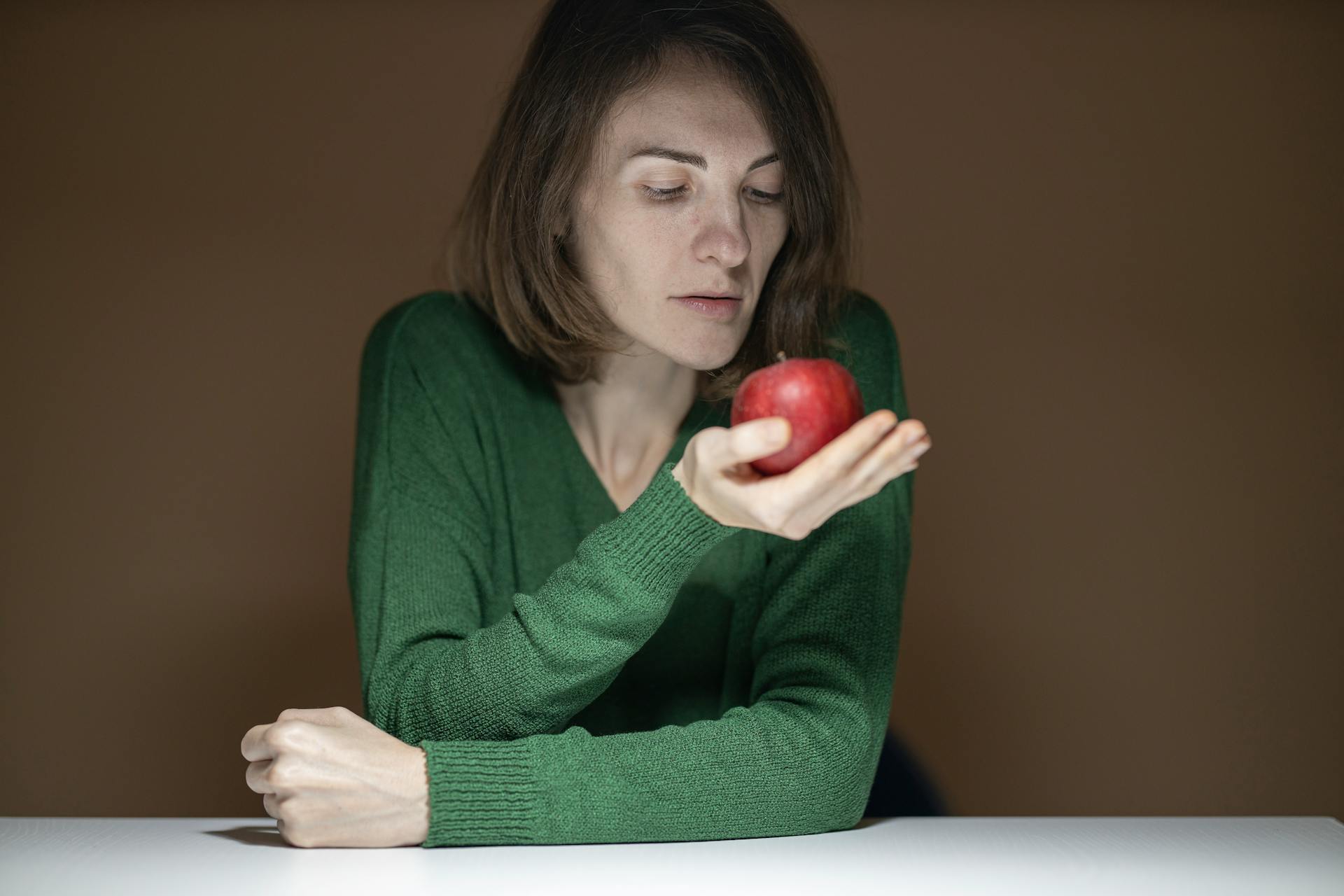 Woman Holding Red Apple