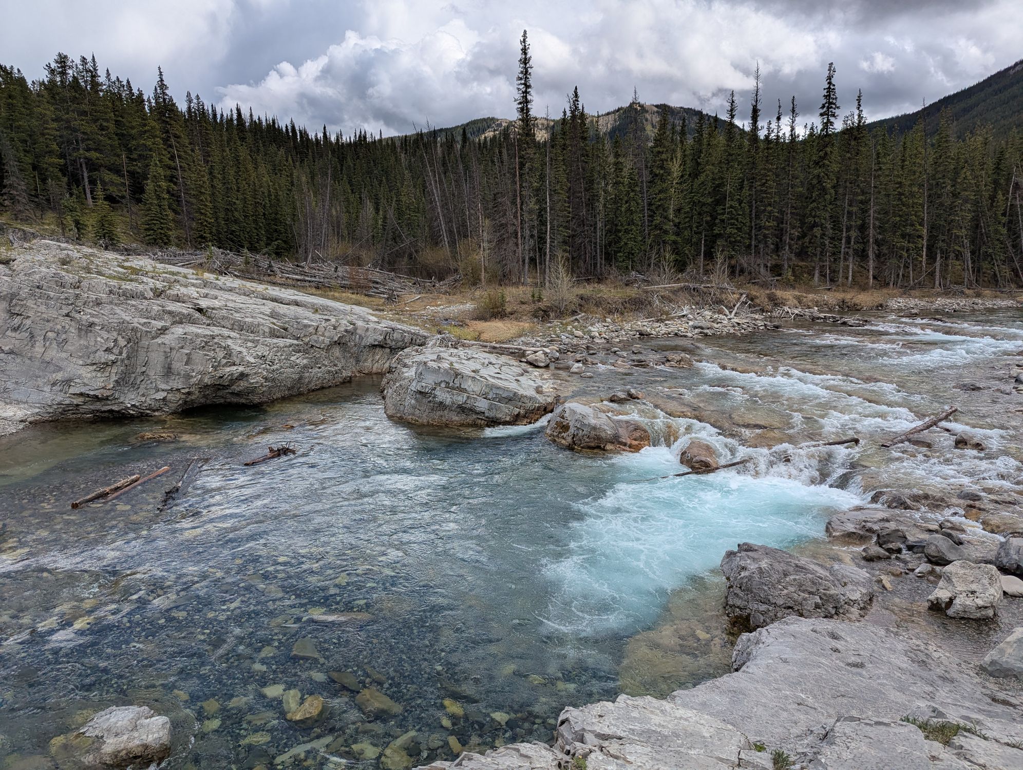Crystal Clear River Flowing Through Rocky Landscape · Free Stock Photo