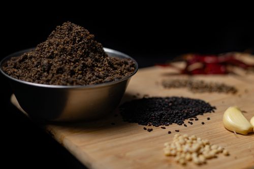 Free Close-up of assorted spices including black sesame and garlic on a wooden board. Stock Photo