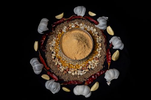 Free Top view of traditional Indian spices and masala surrounded by garlic and chilies on a dark background. Stock Photo