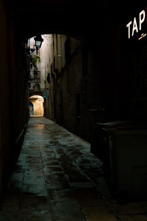 Free Atmospheric photo of a dark, narrow alleyway with dim lighting at night. Stock Photo