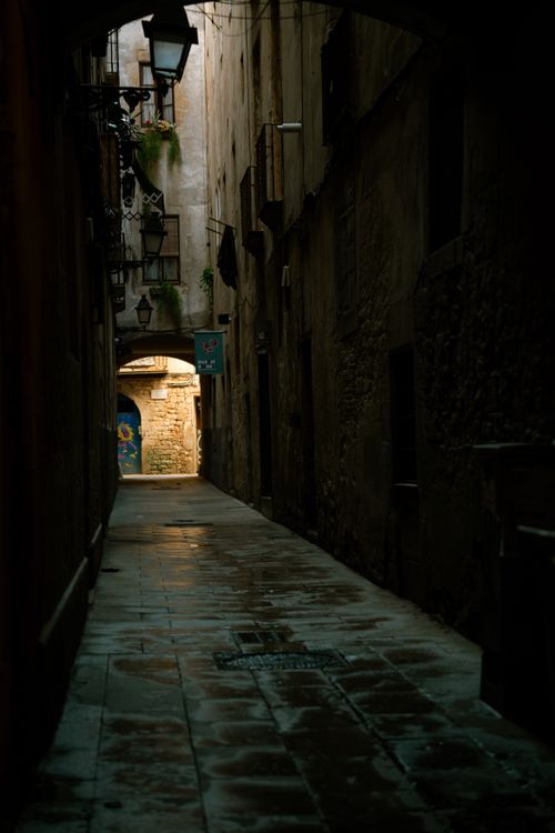 Free Dramatic alleyway at dusk, showcasing rustic architecture with a vintage feel. Stock Photo