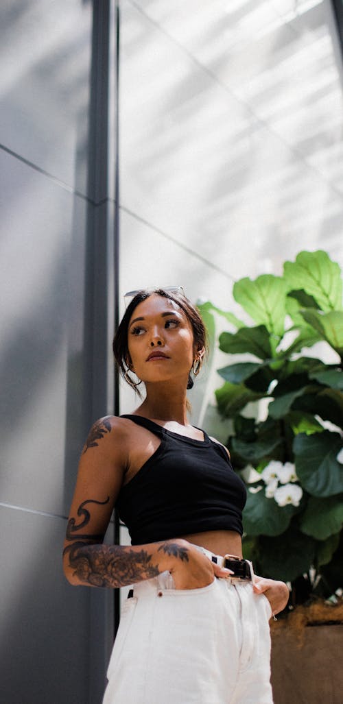 Woman in Black Sleeveless Crop Top and White Bottoms