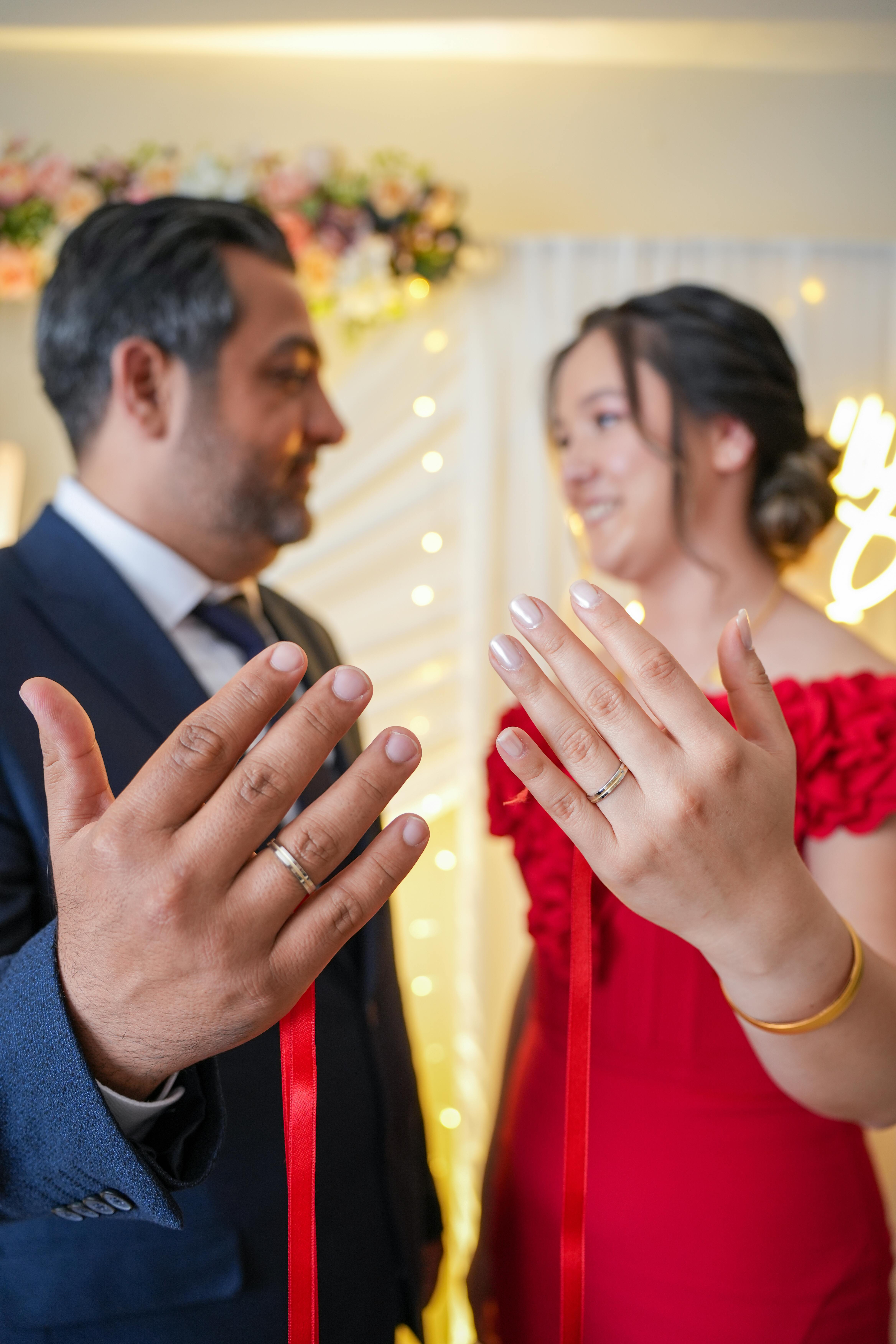 A happy couple showcasing their wedding rings after engagement in a beautiful ceremony.