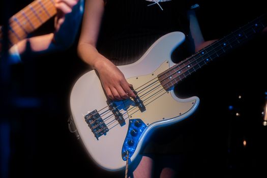 Musician playing bass guitar during live rock concert in Ankara, Türkiye.