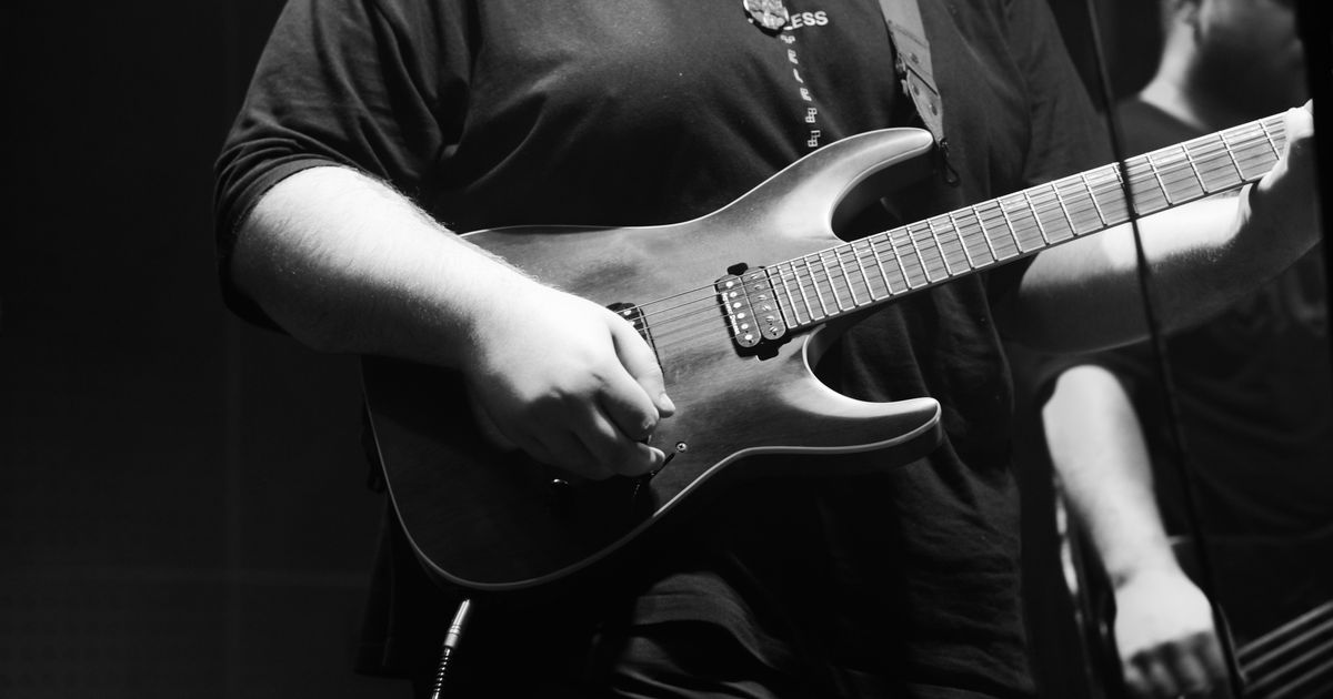 Black and white image of a guitarist playing during a live rock concert in Ankara, Türkiye.