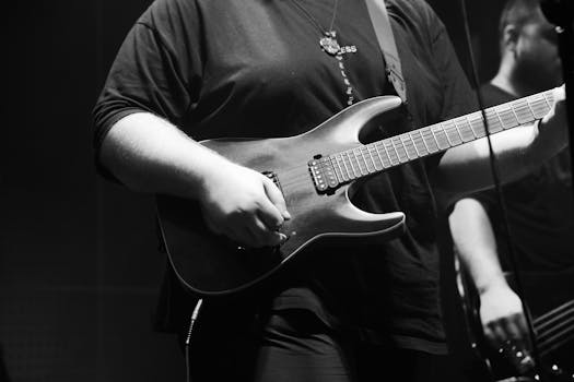 Black and white image of a guitarist playing during a live rock concert in Ankara, Türkiye.