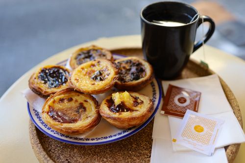 Free Delicious Portuguese tarts paired with Turkish tea in Istanbul's vibrant cafes. Stock Photo