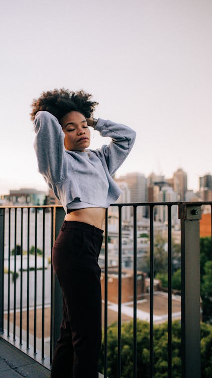 A Woman Wearing Crop Top and Gray Pants · Free Stock Photo
