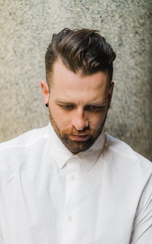 Free Close-up Of A Man In White Buttoned-up Shirt  Looking Down Stock Photo