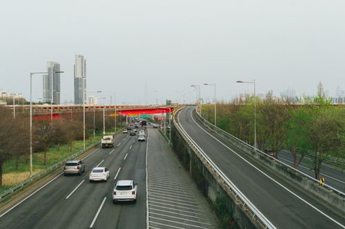 Free An urban highway in Seoul, South Korea, amidst a modern skyline during spring. Stock Photo