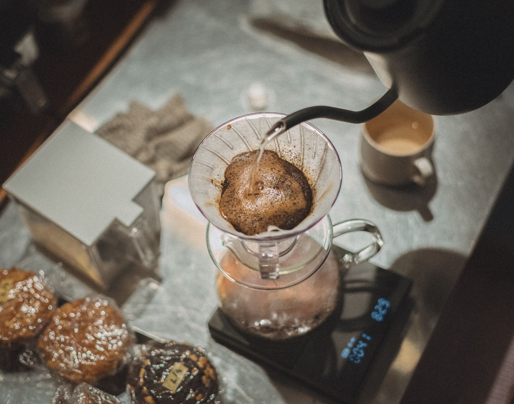 A close-up of hand-brewed pour over coffee being prepared in a Tokyo cafe.