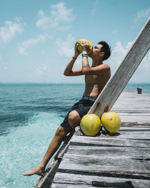 Man Drinking Coconut