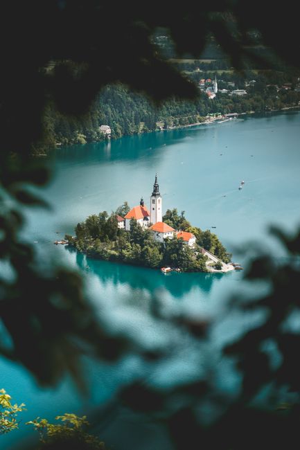 A breathtaking view of the Church of the Assumption on Lake Bled, Slovenia, surrounded by turquoise waters.
