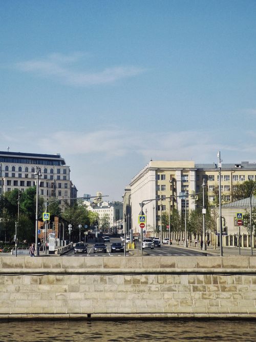 Free Vibrant daytime urban scene with cars and historical architecture in a European city Stock Photo