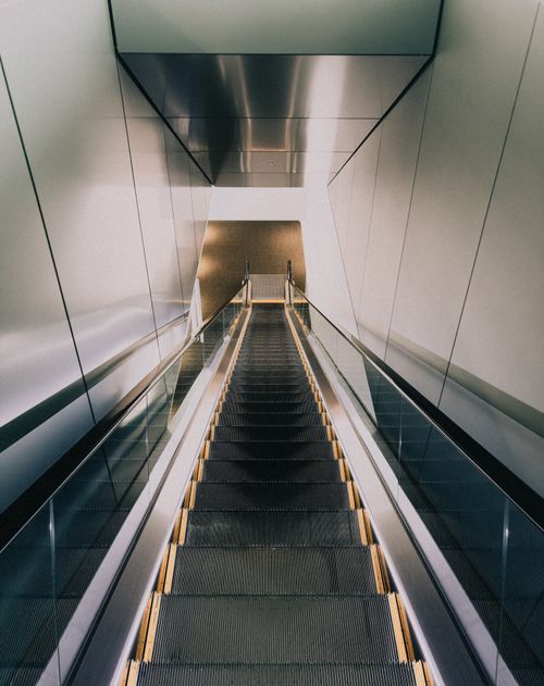 Free A sleek and modern escalator in a minimalist indoor space in Yokohama, Japan. Stock Photo