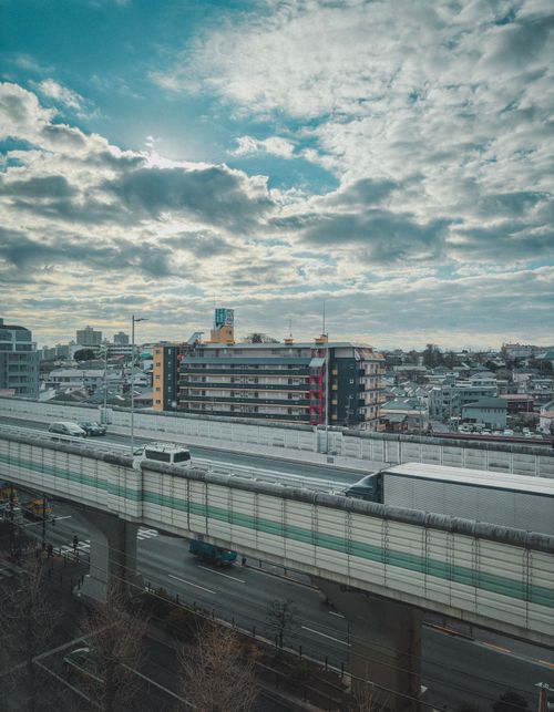 Free Elevated highway view in Itabashi City, Tokyo, with urban skyline and cloudy sky. Stock Photo