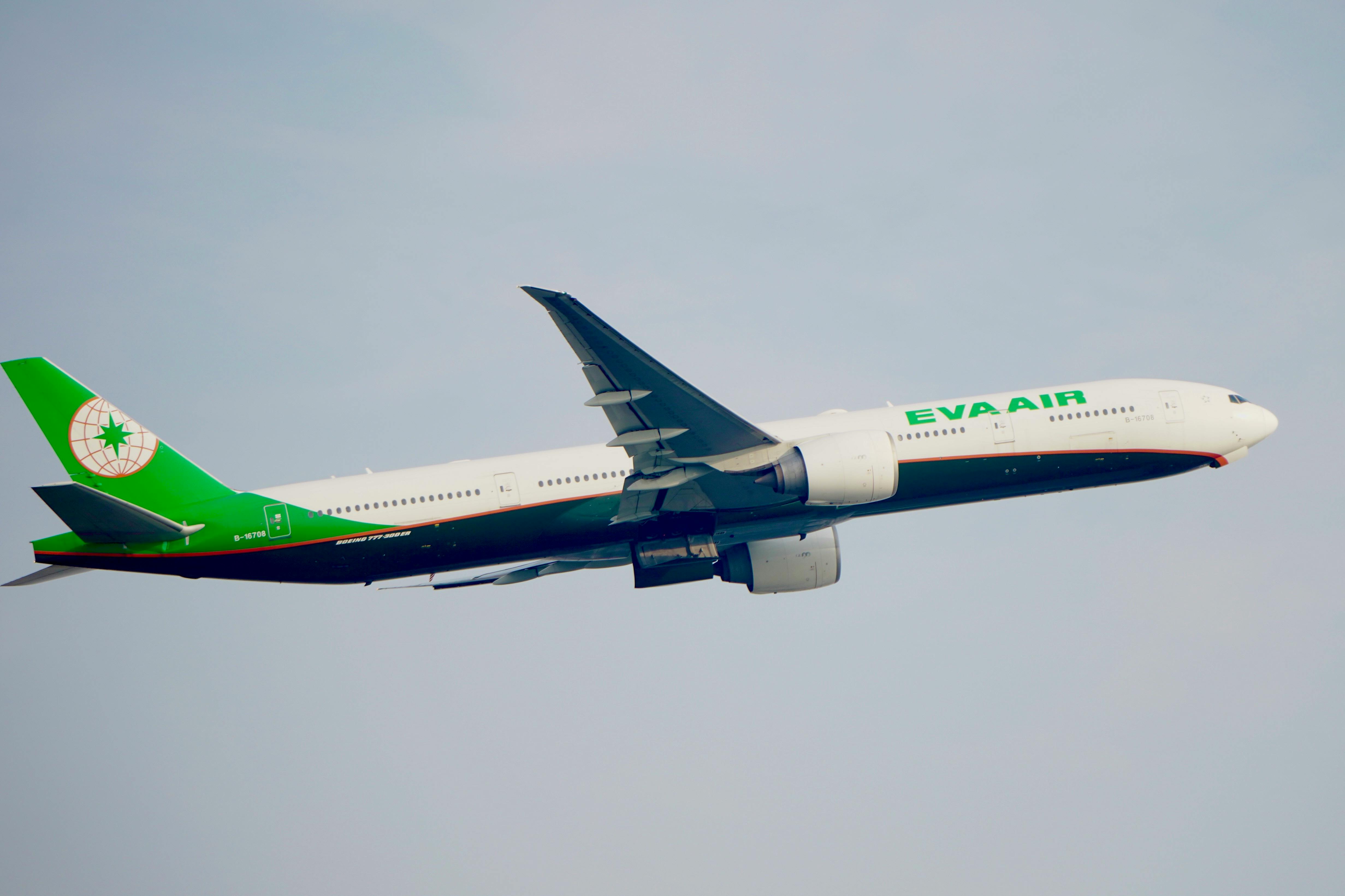 EVA Air Boeing 777-300ER soaring against a clear sky, showcasing aviation elegance.