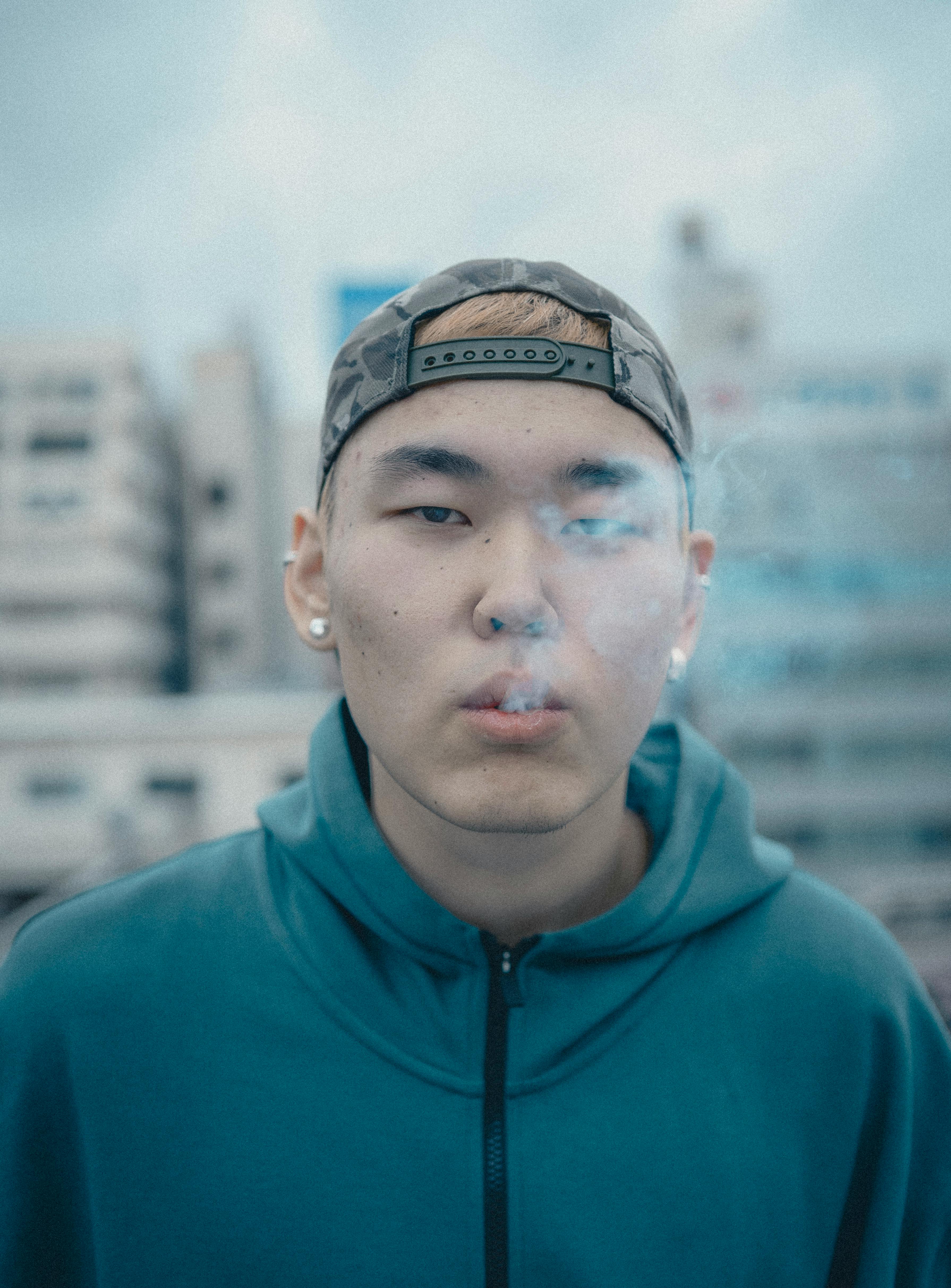 Portrait of a young man smoking in the urban backdrop of Shinjuku, Tokyo.