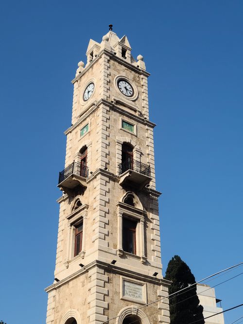 Free Magnificent clock tower with intricate architecture set against a vibrant blue sky. Stock Photo