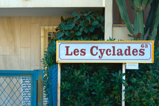 Photograph of the Les Cyclades sign surrounded by greenery in Cannes, Provence-Alpes-Côte d'Azur.