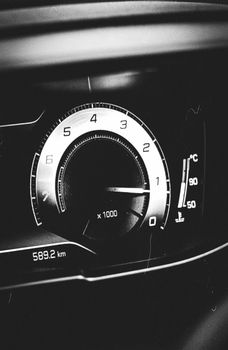 Monochrome close-up of a car speedometer with detailed markings, showing elegance.